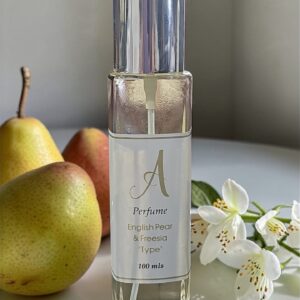 label reads English Pear & Freesia', placed among pears and white flowers on a white surface.
