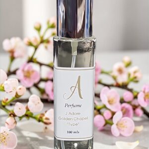 Perfume bottle with metallic cap, label partially legible, surrounded by pink blossoms.